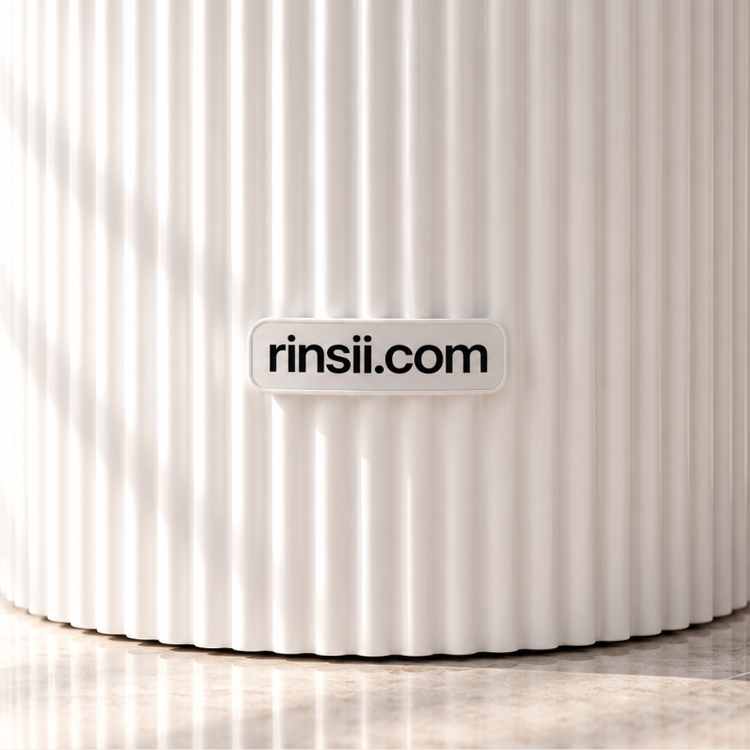 Close-up of the white ribbed tank with the rinsii.com badge